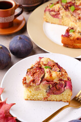 A piece of homemade sweet pie with figs on a white plate