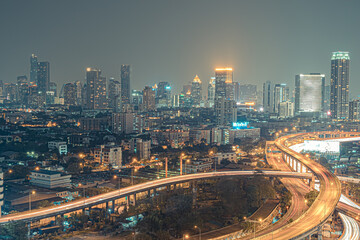 Fototapeta na wymiar Aerial view of the modern buildings and skyscrapers at night of Bangkok City, Thailand.