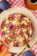 A pie with figs, walnuts and cheese. Autumn still life composition