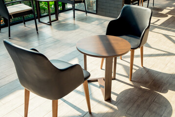 The cozy interior design of the cafe with a table and chair on sunny in the morning. The modern casual coffee shop or restaurant background.