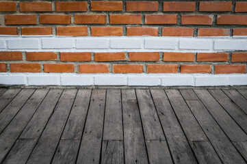 Wood table in front of old brick wall background. Brown wooden desk empty counter in front of the room. Copy space for text and ideal for product placement.