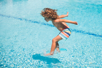 Summer kids holidays. Happy child jump in the sea. Kids jumping on swimming pool.