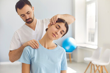 Licensed chiropractor doing neck adjustment to female patient in modern medical office - obrazy, fototapety, plakaty