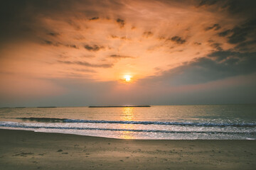 Beautiful golden sunset with blue sky over the horizon on the beach background, Thailand. Tropical twilight colorful sunrise from the landscape sea. Summer ocean vacation concept.