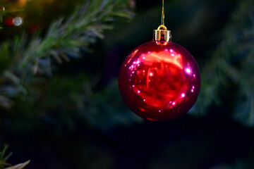 Closeup of Christmas Ball on Christmas Tree with bokeh beautiful background for design and decoration, new year concept, selective focus.