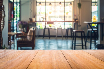 Wood table in front of the cafe blur background. Brown wooden desk in front of the coffee shop. Empty counter in restaurant.