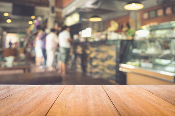 Wood table in front of the cafe blur background. Brown wooden desk in front of the coffee shop. Empty counter in restaurant.