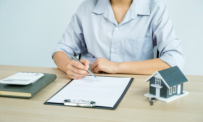 Real estate agent hand holding a pen, point to business contract, rent, buy, mortgage, loan, home insurance