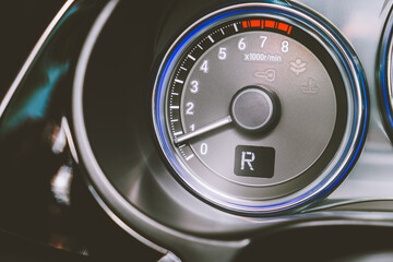 Closeup shot of symbol R show on speedometer in car with LCD display of odometer and trip...