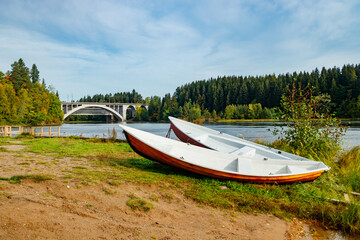 Fototapeta premium Autumn landscape of bridge and boats on Kymijoki river in Finland, Kouvola, Koria