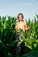 young woman in a corn field in a yellow t-shirt with a place under the text with short hair