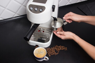 woman make cappuccino on white espresso coffee machine on modern kitchen