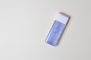 bottle with tonic for health care on yellow colored paper background with copy space