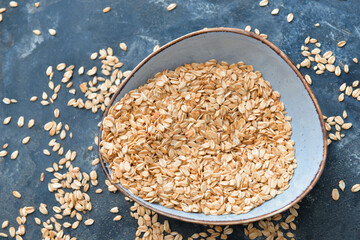 Bowl with raw oatmeal on table
