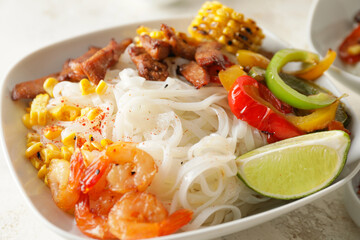 Bowl with tasty rice noodles, closeup