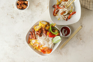 Bowls with tasty rice noodles on table