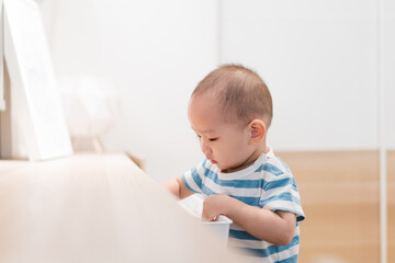 Fototapeta premium A baby boy of one and a half years old is playing in the room