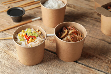 Bowls with tasty rice noodles on table
