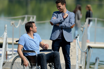 man and man in a wheelchair outdoors