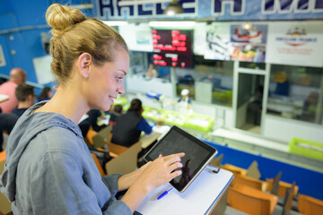 Obraz premium portrait of young attractive woman with tablet in a store