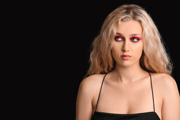 Young woman with beautiful eyeshadows on dark background