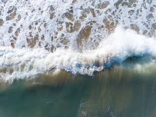 Aerial view of blue sea, waves and beach
