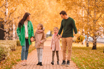 Portrait of happy family of four in autumn day