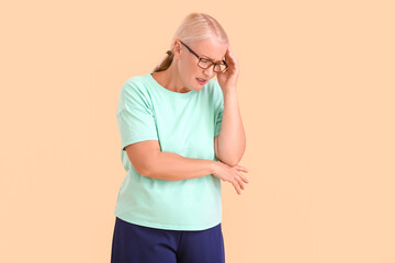 Stressed mature woman on color background