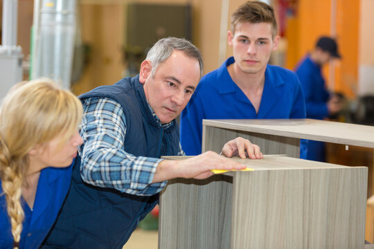 teacher with students in workshop