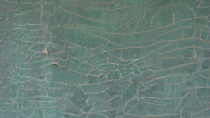 Wood surface with cracked blue paint. Abstract background.