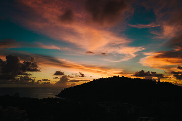 Natural sunset with colorful clouds, gold and blue sky.