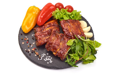 Delicious grilled pork ribs in BBQ sauce on stone plate, isolated on white background