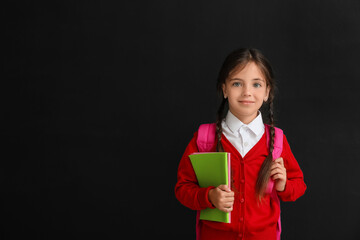 Little schoolgirl on dark background
