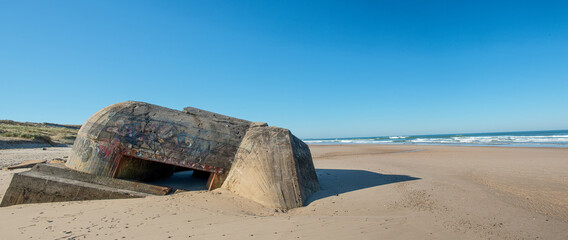 ruins of german bunker in the beach of Normandy, France