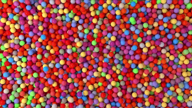 Bath of colored balls in 4K, jumping and floating around. Playful background.