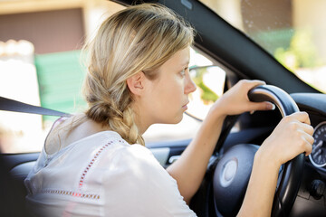 Fototapeta na wymiar portrait of a bored woman driving a car
