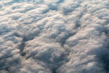 hot air balloon breaking through the clouds
