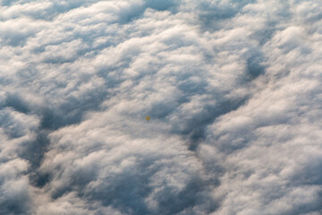 Fototapeta na wymiar hot air balloon breaking through the clouds