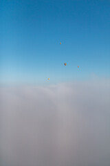 hot air balloons over the clouds