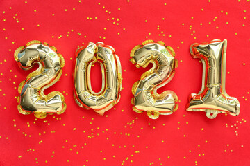 Balloons in shape of figure 2021 on color background. New Year celebration