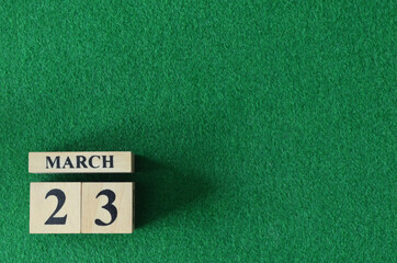 March 23, number cube on snooker table, sport background.