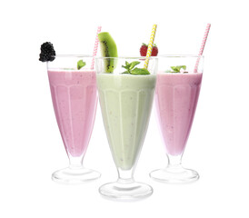 Tasty fresh milk shakes with berries on white background