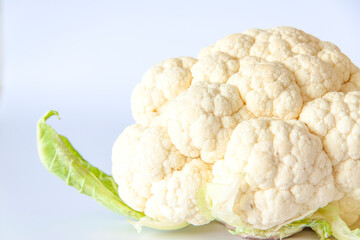 Whole cauliflower on a light background. Vegetarianism.