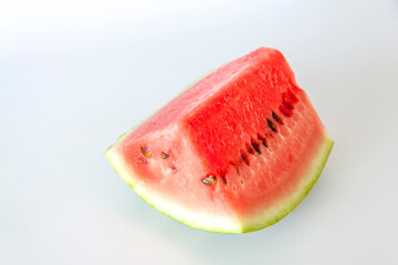 Red ripe watermelon sliced on a white background.