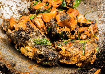 Frying  chopped head snake  fish with chili paste  in pan , in door  Chiangmai  Thailand