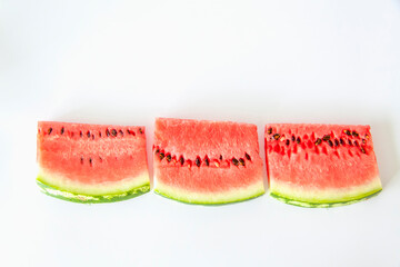 Red ripe watermelon sliced on a white background.