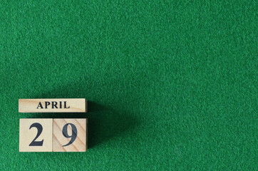 April 29, number cube on snooker table, sport background.