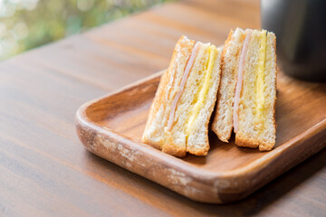 Grilled cheese sandwich with hot latte on wooden table in cafe. Cup of coffee the best start to any morning.