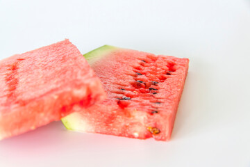 Red ripe watermelon sliced on a white background.