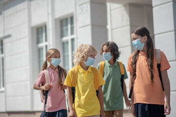 Schoolchildren in protective masks on their way home after school